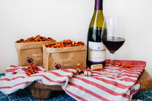Murphy-Goode Wine bottle with brown bag snacks on a table