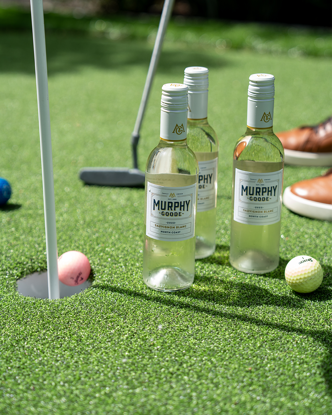 Murphy-Goode Sauvignon Blanc with friends on a putting green and golf balls