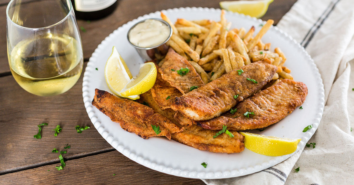 Fish Fry with french fries and a glass of white wine