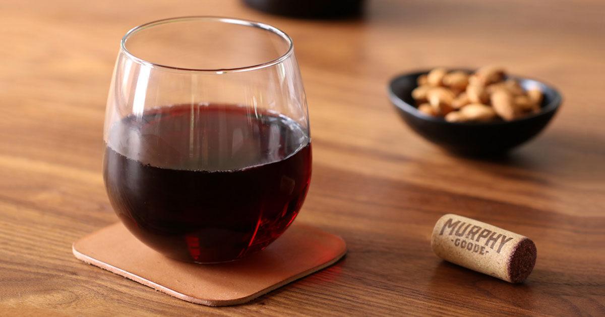 Leather coster with stemless wine glass on a table