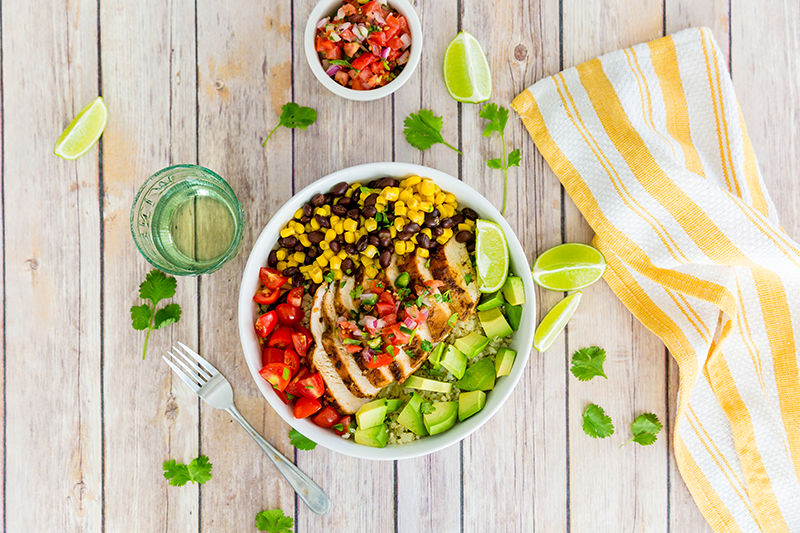Cauliflower Rice Bowl with Chicken on a table with Murphy-Goode Wine bottle Cauliflower Rice Bowl with Chicken on a table with Murphy-Goode Wine bottle