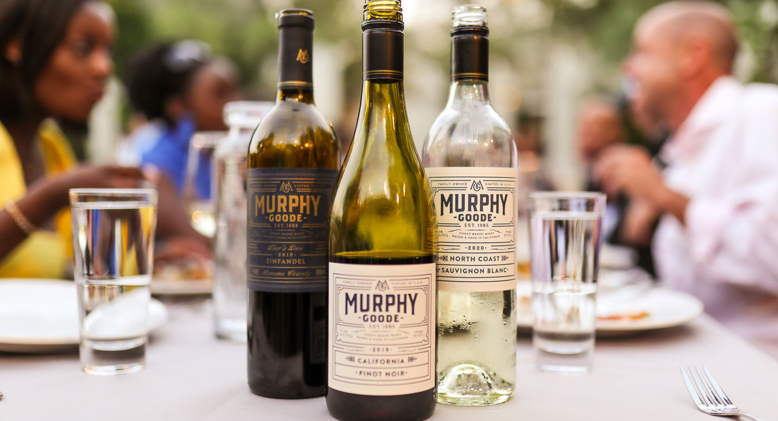 Three wine bottles of Murphy-Goode sitting on table.