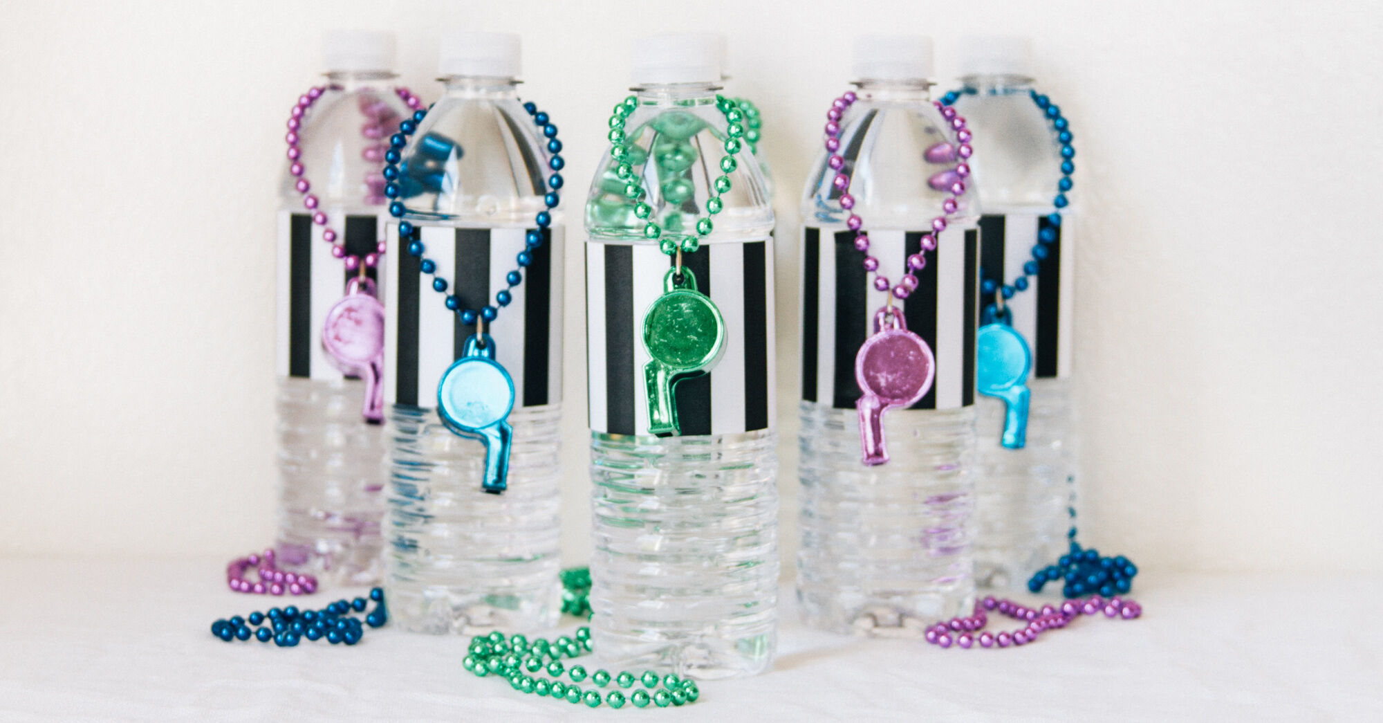 Water bottles with referee labels and whistle necklaces