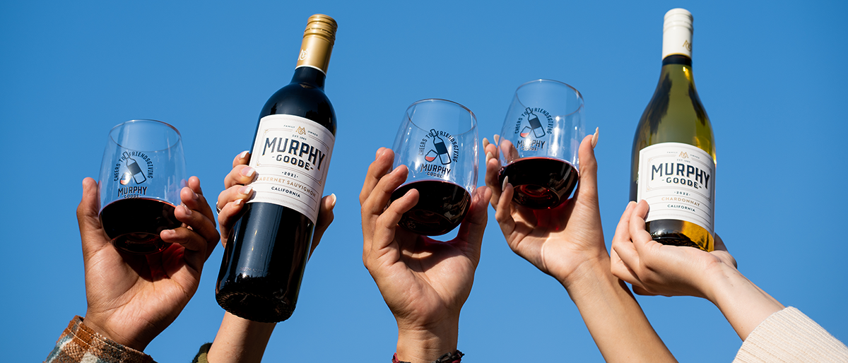 Diverse hands holding wine bottles and wine glasses, Murphy-Goode